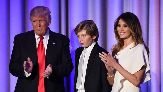 Donald Trump arrives with his son Barron and wife Melania at the New York Hilton Midtown, on Nov. 8, 2016. 
Trump stunned America and the world Wednesday, riding a wave of populist resentment to defeat Hillary Clinton in the race to become the 45th president of the United States.