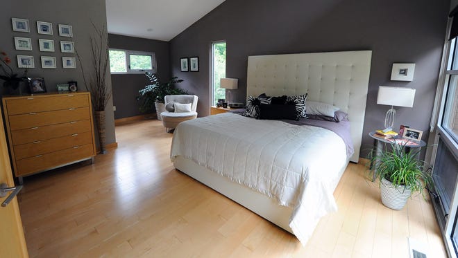 Converging lines of the ceiling and wood floor add depth to Mark Sorenson and Kathy O'Brien Sorensen's master bedroom.