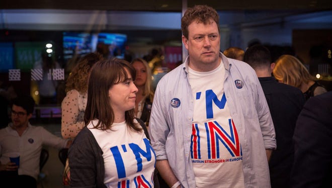 Supporters of the 'Stronger In' Campaign react as results of the EU referendum are announced at a results party at the Royal Festival Hall in London early in the morning of June 24, 2016.