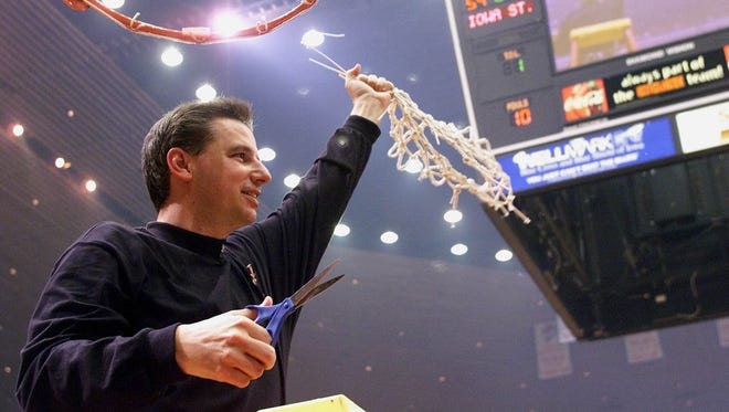 Iowa State head coach Larry Eustachy takes down the net after Iowa State defeated Nebraska to win its second consecutive Big 12 championship on Saturday, March 3, 2001.