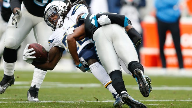 San Diego Chargers running back Melvin Gordon (28) is tackled by Carolina Panthers cornerback Daryl Worley (26) in the first quarter at Bank of America Stadium.