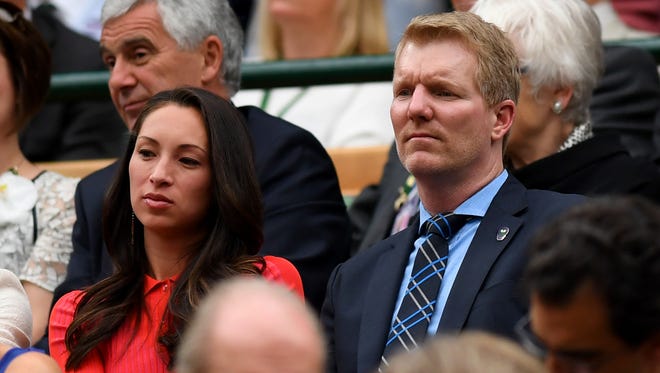 Jim Courier and wife Susanna look on from the Centre Court royal box prior to the women's final on day twelve.