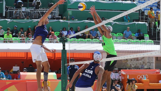 Phil Dalhausser of the United States spikes over Juan Ramon Virgen Pulido of Mexico during the men's preliminary in Rio 2016 Summer Olympic Games at Beach Volleyball Arena.