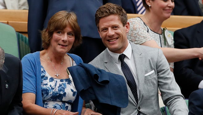Actor James Norton and his mother Valerie take their seats for the Women's Singles final match on day twelve.