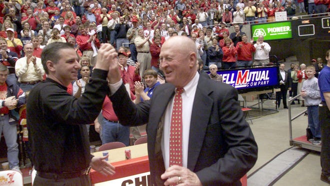 Former Iowa State men's basketball coach Johnny Orr, right, gives a high five to head coach Larry Eustachy before the Cyclones' Feb 26, 2000, game against No. 10 Oklahoma State in Ames. The Cyclones won, 72-61.