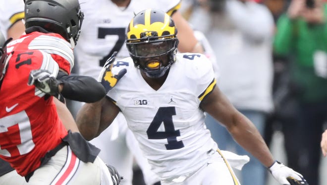 Michigan's De'Veon Smith pursues Ohio State's Jerome Baker after Baker intercepted a pass deep in Wolverines' territory in the third quarter Saturday, Nov. 26, 2016 at Ohio Stadium.