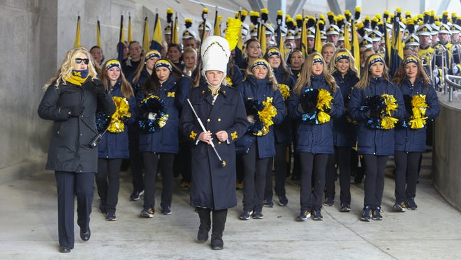 Michigan cheerleaders and marching band members arrive for the game against Ohio State on Saturday, November 26, 2016 at Ohio Stadium in Columbus.