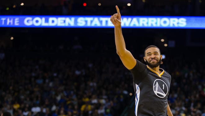 Warriors center JaVale McGee (1) acknowledges the fans after a play against the Phoenix Suns during the third quarter at Oracle Arena.