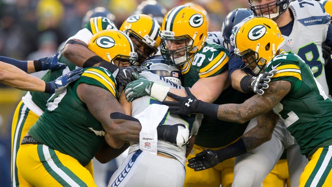 Seahawks running back Thomas Rawls (34) is tackled during the first quarter against the Packers.