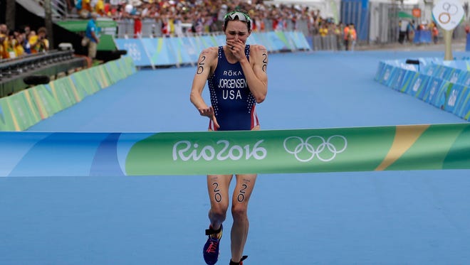 Gwen Jorgensen of the United States wins the women's triathlon competition of the 2016 Summer Olympics in Rio de Janeiro, Brazil, Saturday, Aug. 20, 2016. (AP Photo/Gregory Bull) ORG XMIT: OBUL109