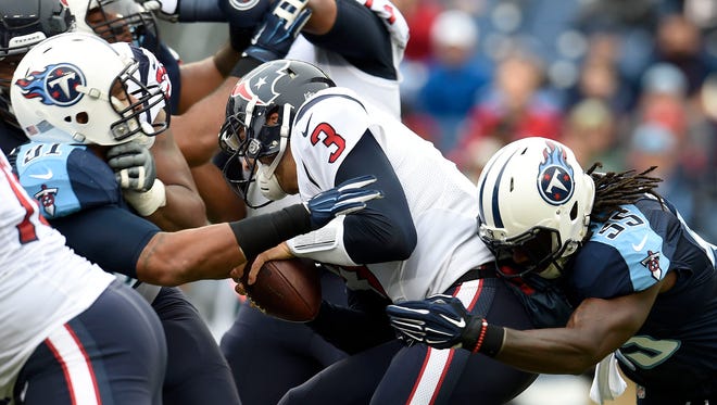 Tennessee Titans inside linebacker Sean Spence (55) knocks the ball out of the hands of Houston Texans quarterback Tom Savage (3) in the first quarter during the NFL game at Nissan Stadium.