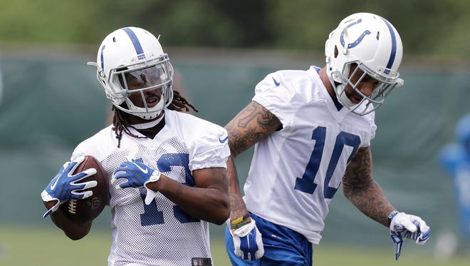Indianapolis Colts' T.Y. Hilton (13) makes a catch against Donte Moncrief (10) during the team's organized team activities at its NFL football training facility, Tuesday, May 23, 2017, in Indianapolis.