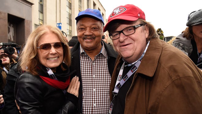 Gloria Steinem, left, Rev. Jesse Jackson and Michael Moore attend the rally at the Women's March on Washington.