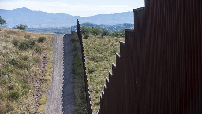A fence runs along a portion of the U.S.-Mexico border in Arizona. President Donald Trump has said he wants to build a fence along the entire length of the border, and Wednesday the first lawsuit challenging his proposal was filed.