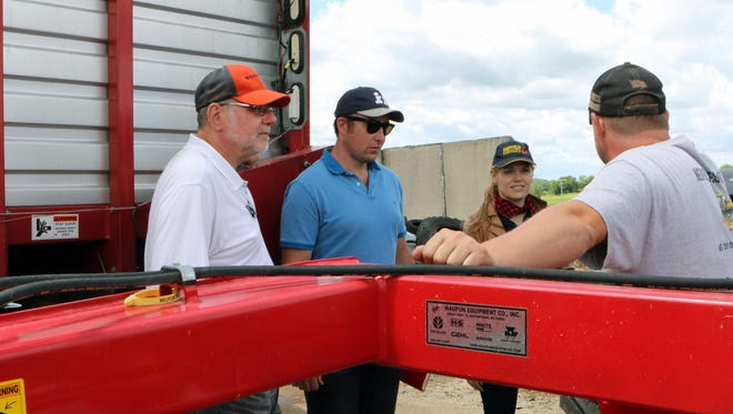 Troy Schlender (right), a third generation farmer in Jefferson County, talks about the machinery he uses on his farm, Never Rest Dairy, during a visit from 11 Nuffield scholars on June 19. It's the first time the scholar group has stopped in Wisconsin as part of its world-wide tour.