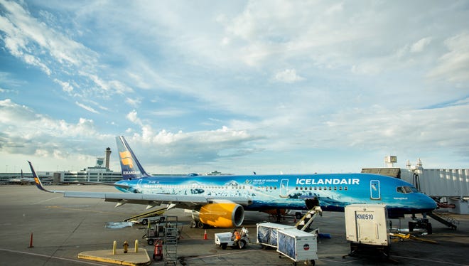 An Icelandair Boeing 757 with a very unique paint scheme offloads passengers at Denver International Airport in July of 2017.