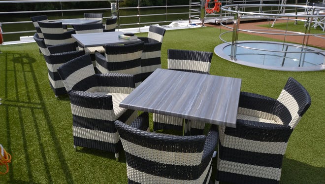 Tables and chairs atop the Scenic Gem. On fair-weather days, passengers can lounge atop the vessel while it is sailing.