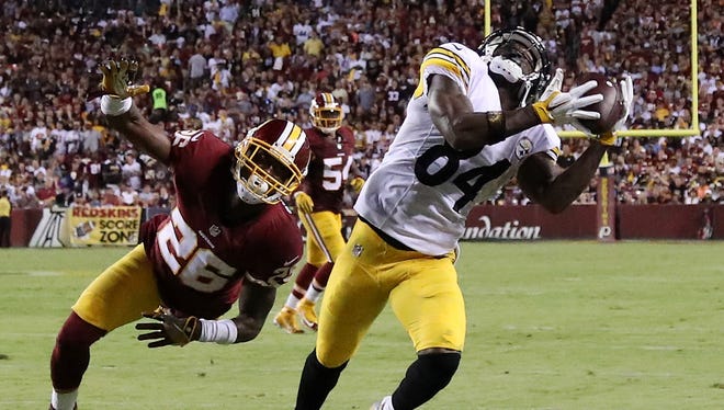 Steelers receiver Antonio Brown (84) hauls in a touchdown catch behind Redskins defender Bashaud Breeland (26) during the third quarter.
