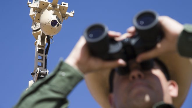 Border Patrol Agent Marcos Soto monitors with high tech security cameras to keep an eye on United States border at one of remote locations.