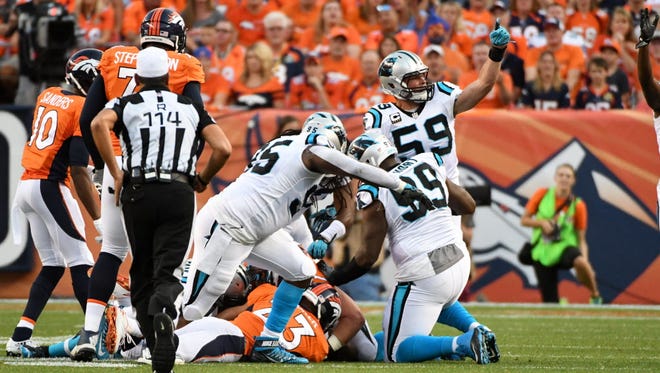 Denver Broncos running back Devontae Booker (23) fumbles the ball to the Carolina Panthers in the first quarter.