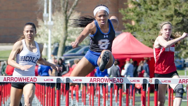Oak Creek's Jazmin Washington leads second-place Destiny Huven of Nicolet and Sun Prairie's Carly Coulthart over the final hurdle in the girls 100-meter hurdles at the Myrhum Invitational track and field meet Saturday at Arrowhead High School in the Town of Merton.