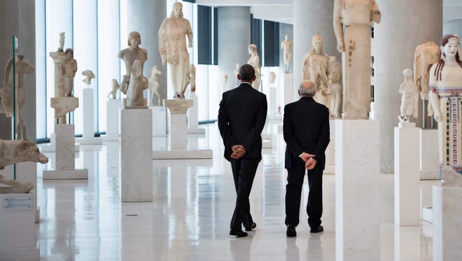 Obama walks with Professor Dimitrios Pandermalis, president of the Acropolis Museum, during a tour of the Acropolis Museum on Nov. 16, 2016, in Athens, Greece.