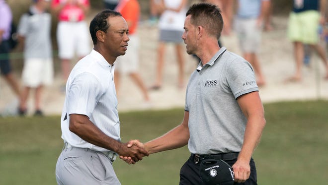 Tiger Woods shakes hands with Henrik Stenson on the 18th hole after the second round of the Hero World Challenge.