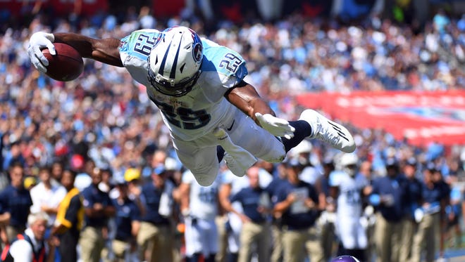 Tennessee Titans running back DeMarco Murray (29) leaps over Minnesota Vikings cornerback Terence Newman (23) for a touchdown during the first half at Nissan Stadium.