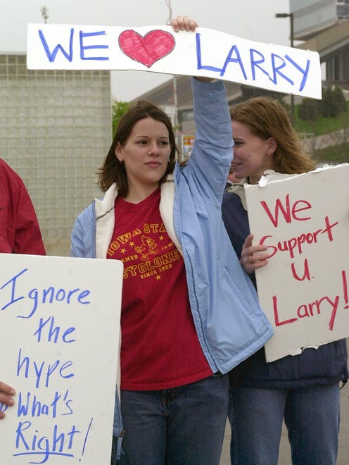 Iowa State student Jamie Luedtke holds up a sign in support of basketball coach Larry Eustachy on the Iowa State campus on Wednesday April 30, 2003, in Ames, Iowa. Eustachy spoke at a news conference Wednesday after photographs were published of him partying with college students in Missouri. Eustachy says he is an alcoholic and has sought treatment, but he will not resign as basketball coach at Iowa State.