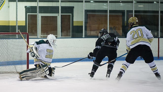 Howell goalie Nathan George makes one of his 22 saves on a shot by Eric Budd of Ann Arbor Gabriel Richard.