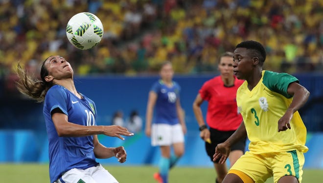 Brazil midfield Marta controls the ball against South Africa defender Nothando Vilakazi.