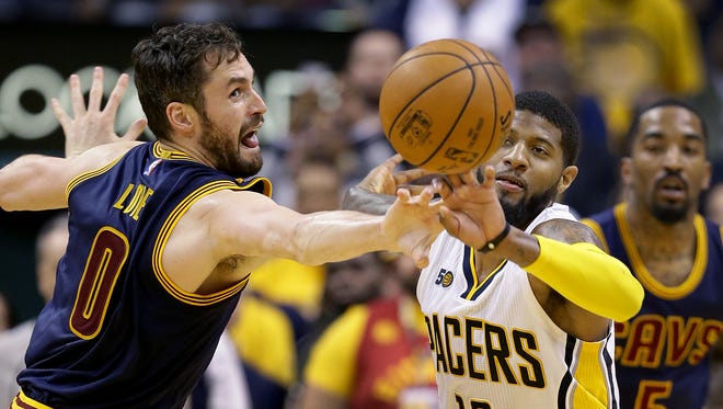 Cleveland Cavaliers forward Kevin Love (0) attempts to knock the ball away from Indiana Pacers forward Paul George (13) in the second half of their NBA playoff basketball game Sunday, April 23, 2017, afternoon at Bankers Life Fieldhouse. The Pacers lost to the Cavaliers 106-102.
