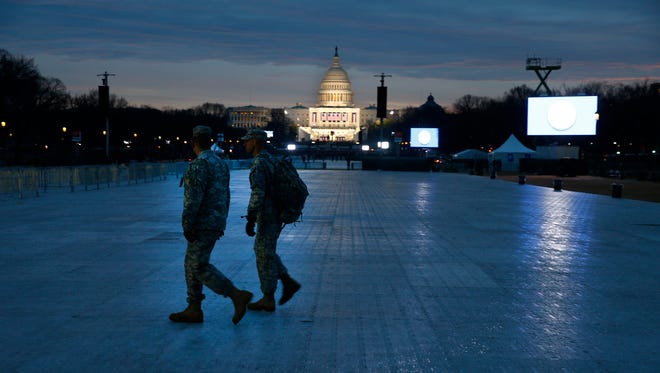 Two National Guard members walk across the National Mall at around 7 a.m., before the 2017 Presidential Inauguration.