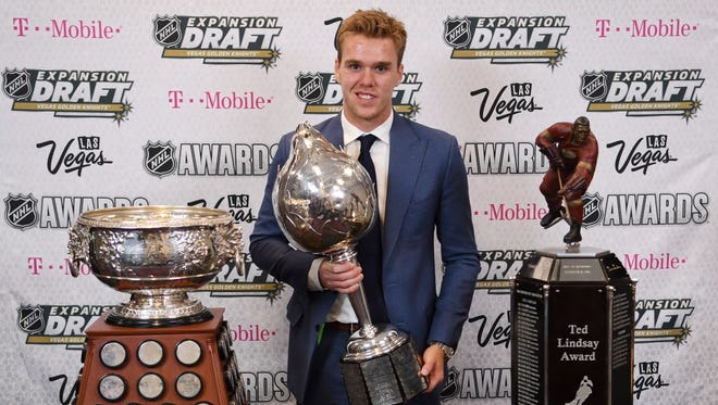 Edmonton Oilers forward Connor McDavid won, from left to right, the Art Ross Trophy (most points), Hart Trophy (MVP) and Ted Lindsay Award (players' MVP).