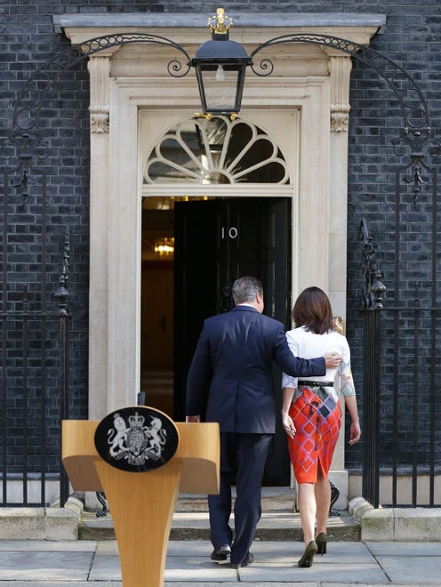 Britain's Prime Minister David Cameron puts his arm around his wife Samantha after speaking outside 10 Downing Street on June 24, 2016. Cameron says he will resign by the time of party conference in the fall after  Britain voted to leave the European Union after a bitterly divisive referendum campaign, according to tallies of official results Friday.