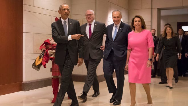 Obama arrives with House Minority Leader Nancy Pelosi, Senate Minority Leader Chuck Schumer and Rep. Joseph Crowley to attend a meeting with Democratic members of Congress on Capitol Hill on Jan. 4, 2017.