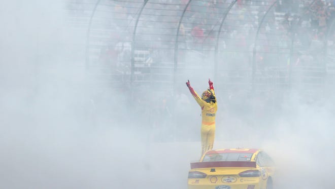 NASCAR Sprint Cup Series driver Joey Logano celebrates after winning the Sylvania 300 at New Hampshire Motor Speedway.