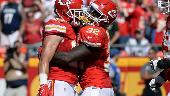 Kansas City Chiefs running back Charcandrick West (35) celebrates with tight end Travis Kelce (87) after a touchdown against the San Diego Chargers in the second half at Arrowhead Stadium.