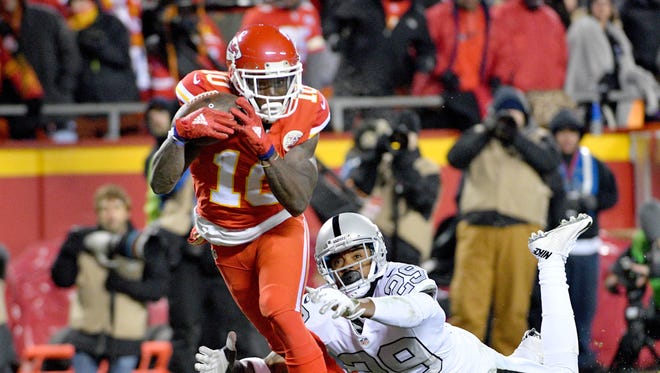 Kansas City Chiefs wide receiver Tyreek Hill (10) runs in for a touchdown as Oakland Raiders cornerback David Amerson (29) attempts the tackle during the first half at Arrowhead Stadium.