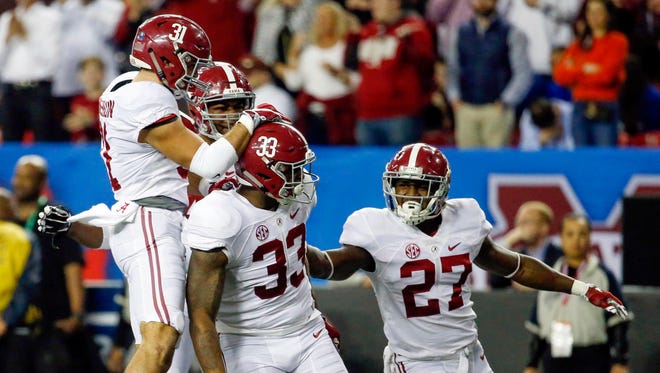Alabama Crimson Tide linebacker Anfernee Jennings (33) celebrates a tackle with teammates during the second quarter of the SEC Championship.