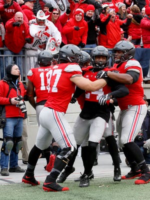 Ohio State's Malik Hooker celebrates with teammates after returning an interception for a touchdown against Michigan at Ohio Stadium on Saturday, Nov. 26, 2016.