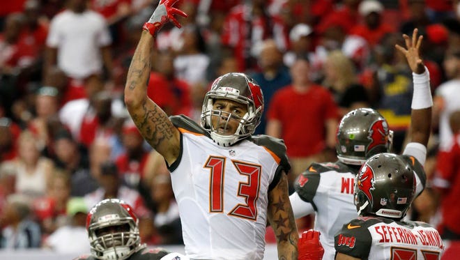Tampa Bay Buccaneers wide receiver Mike Evans (13) celebrates after scoring a touchdown in the third quarter against the Atlanta Falcons at the Georgia Dome.