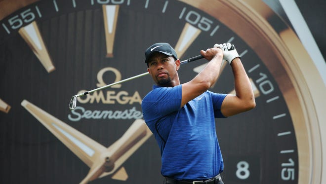 Tiger Woods tees off on the 7th hole during the first round of the Dubai Desert Classic at Emirates Golf Club.