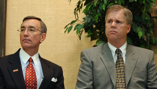 Iowa State President Gregory Geoffroy, left, sits with Athletic Director Bruce Van De Velde, right, after announcing Iowa State had accepted basketball coach Larry Eustachy's resignation, May 5, 2003, in Ames, Iowa.