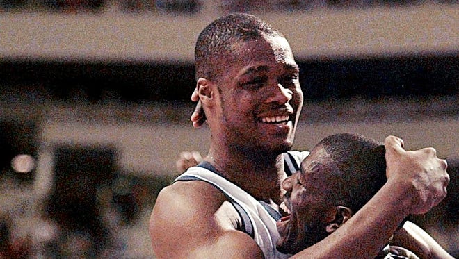 1996: Antoine Walker hugs teammate Tony Delk in the last few minutes of their victory over Wake Forest.
