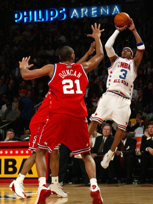Allen Iverson shoots despite defense by Tim Duncan at the NBA All-Star Game.