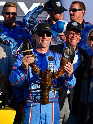 Kevin Harvick celebrates with the traditional lobster given to the winner at New Hampshire Motor Speedway.