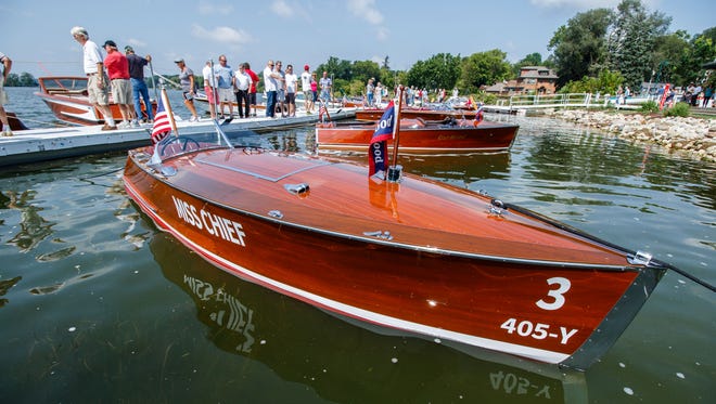 Enthusiasts take in the beauty of classic wooden boats during the 13th Annual Antique & Classic Boat Show at Pewaukee's Lakefront Park on Saturday, August 19, 2017. The event features vintage boats, a classic car show, vintage bicycles, live music, food and much more.