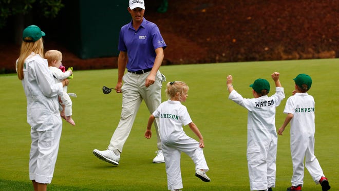 Webb Simpson celebrates with his children and the children of Bubba Watson during the Par 3 Contest.
