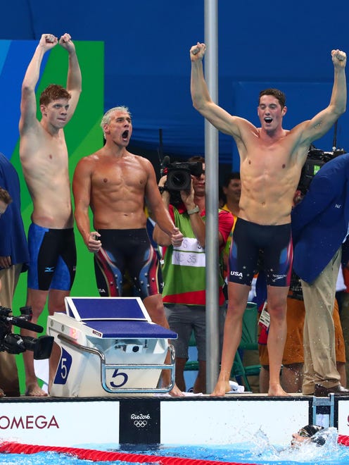 Townley Haas, Conor Dwyer and Ryan Lochte celebrate as Michael Phelps closes out their men's 4x200-meter freestyle relay win.